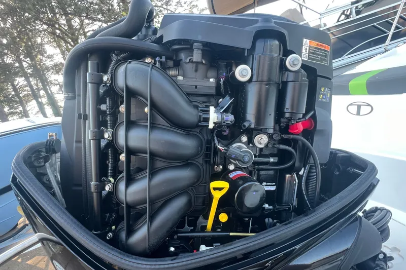 Slide: The Image of Close-up of a 2023 Tahoe T18 boat engine, showcasing intricate mechanical components. - 16