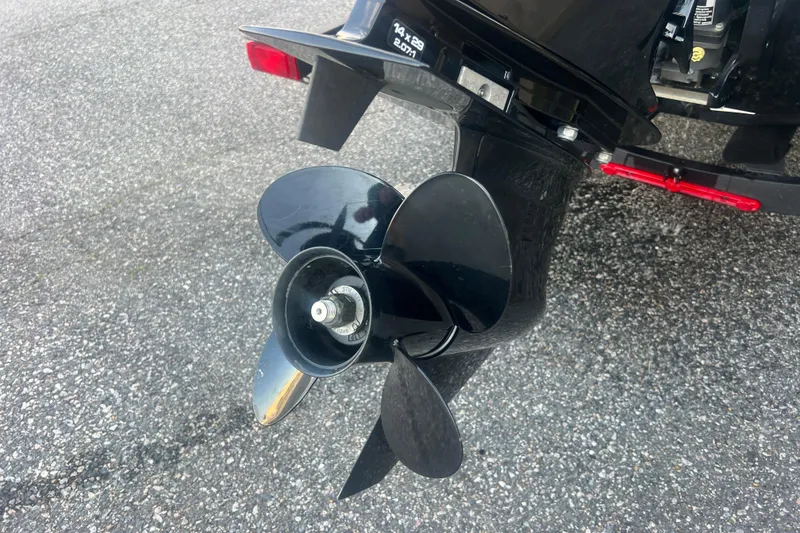 Slide: The Image of 2023 Tahoe T18 boat propeller on asphalt surface, showcasing sleek black blades. - 17