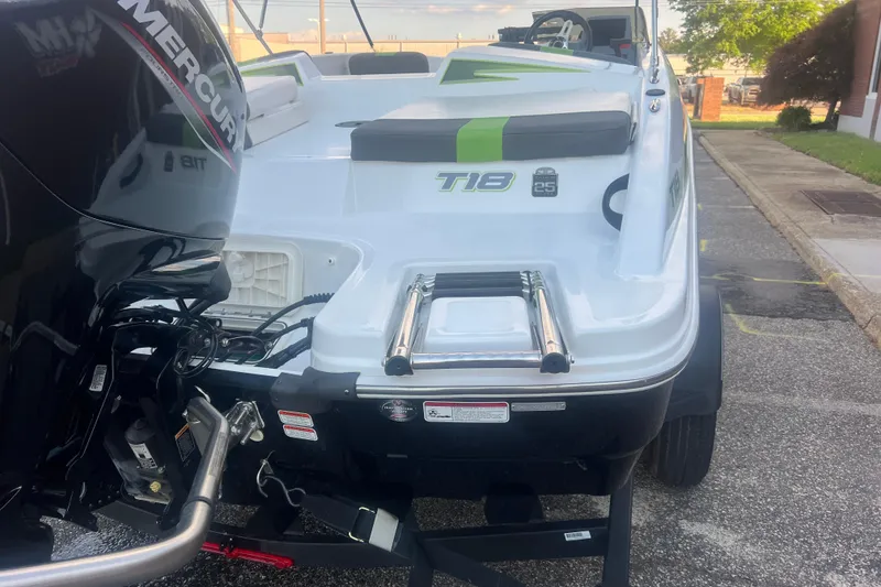 Slide: The Image of 2023 Tahoe T18 boat with Mercury engine, featuring rear ladder and sleek design. - 18