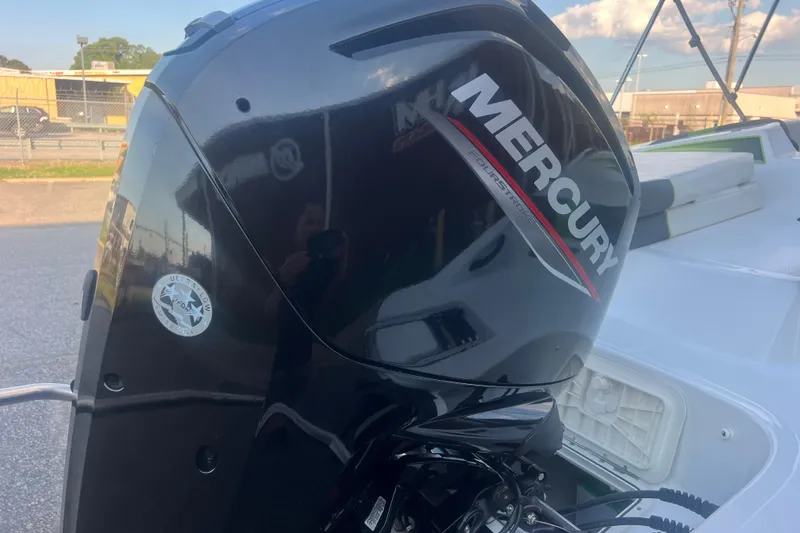 Slide: The Image of Mercury outboard motor on 2023 Tahoe T18 boat, parked outdoors. - 19