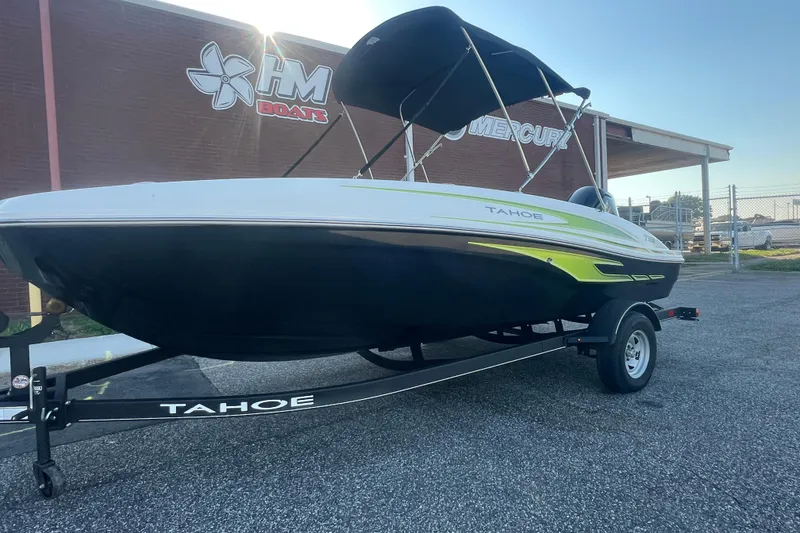 Slide: The Image of 2023 Tahoe T18 boat on trailer, parked outside HM Boats dealership. - 2