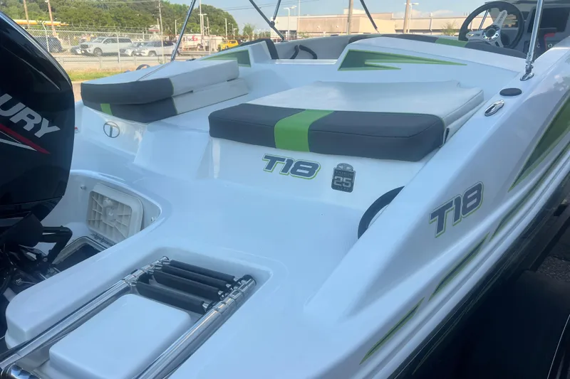 Slide: The Image of 2023 Tahoe T18 boat with Mercury engine, featuring green and white seating. - 21