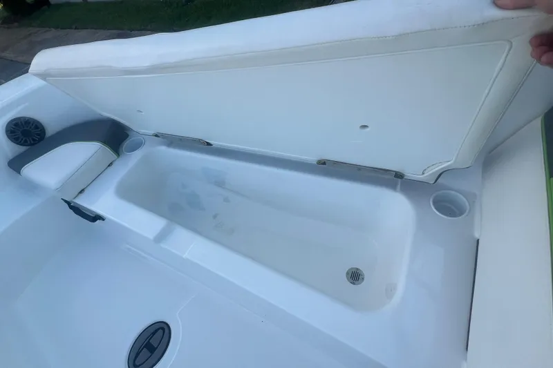 Slide: The Image of 2023 Tahoe T18 boat storage compartment with open lid, showcasing interior space. - 28