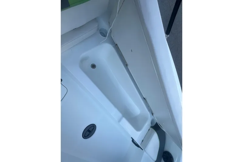 Slide: The Image of Interior view of a 2023 Tahoe T18 boat, showcasing sleek white design and storage features. - 29