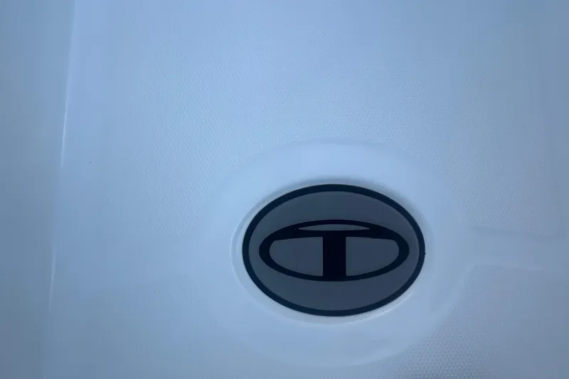Slide: The Image of 2023 Tahoe T18 logo on a white textured surface. - 31