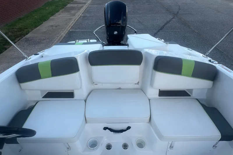 Slide: The Image of 2023 Tahoe T18 boat interior with gray and green seating, outboard motor visible. - 33