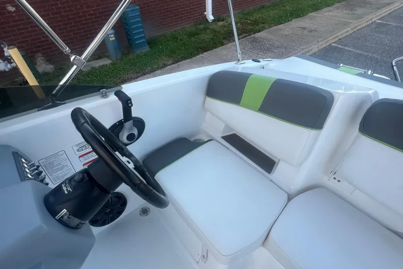 Slide: The Image of 2023 Tahoe T18 boat interior with steering wheel and cushioned seating. - 34