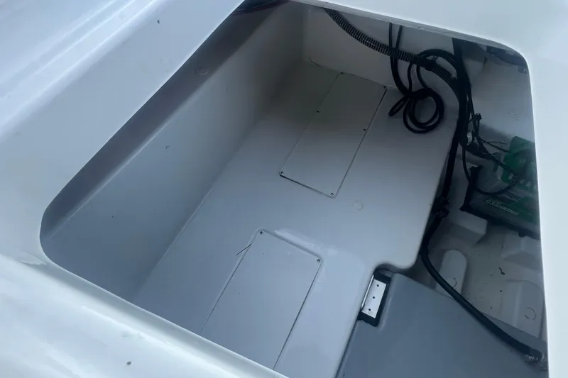Slide: The Image of 2023 Tahoe T18 boat storage compartment with wiring and battery visible. - 38