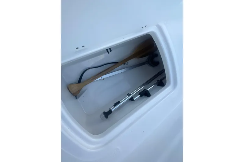 Slide: The Image of Storage compartment in 2023 Tahoe T18 boat with paddles and equipment. - 46