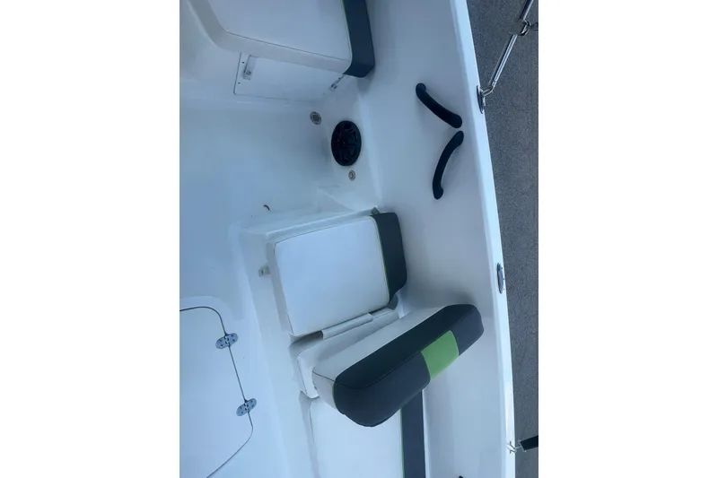 Slide: The Image of 2023 Tahoe T18 boat interior with cushioned seating and storage compartments. - 47