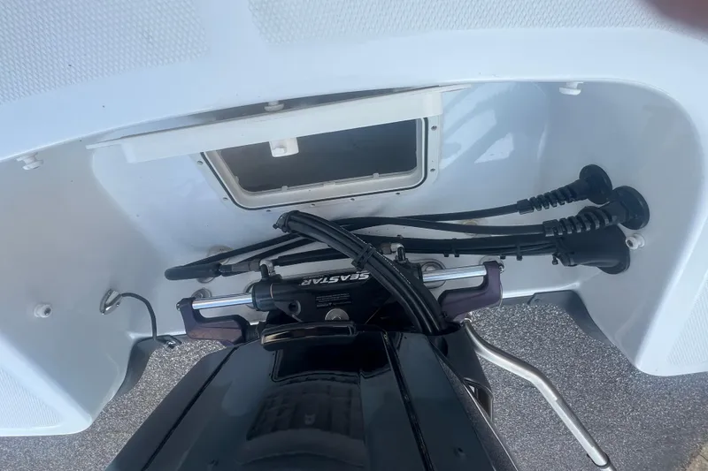 Slide: The Image of 2023 Tahoe T18 boat engine compartment with cables and hydraulic system. - 48