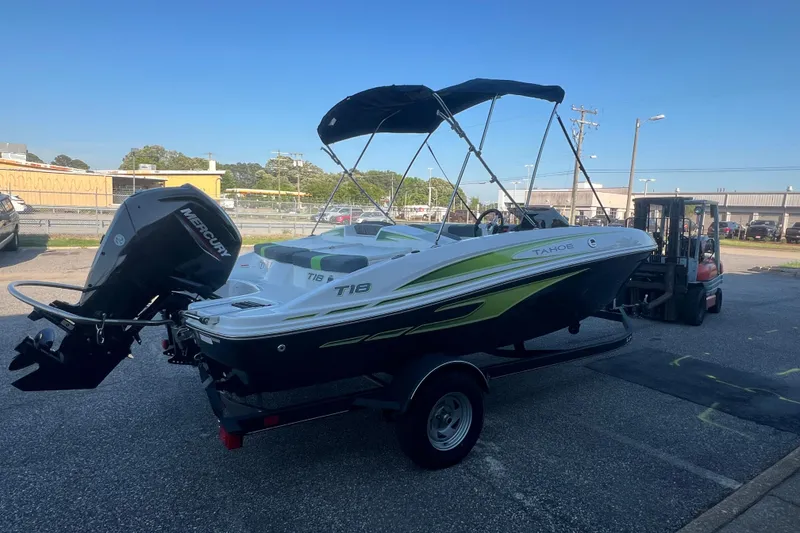 Slide: The Image of 2023 Tahoe T18 boat with Mercury engine on trailer, parked outdoors. - 5