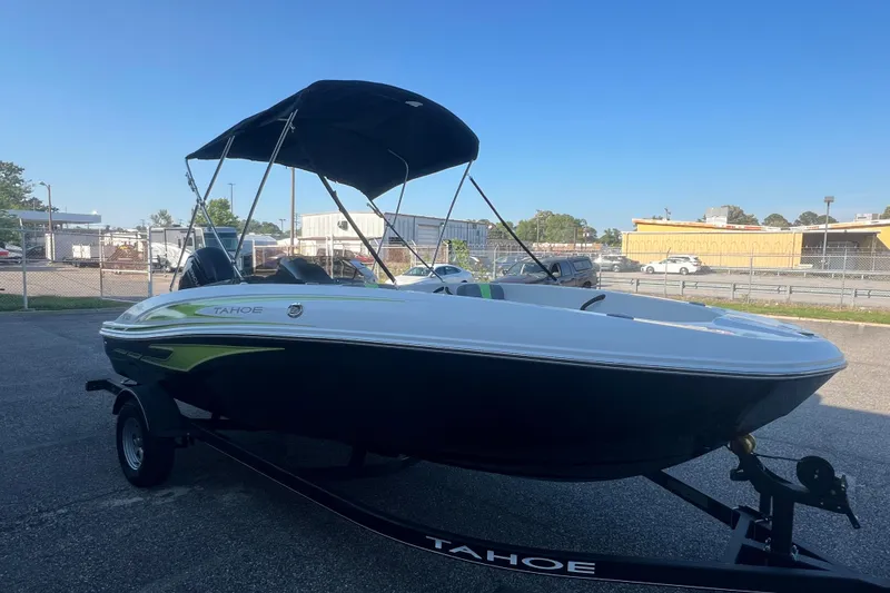 Slide: The Image of 2023 Tahoe T18 boat with canopy on trailer in parking lot. - 8