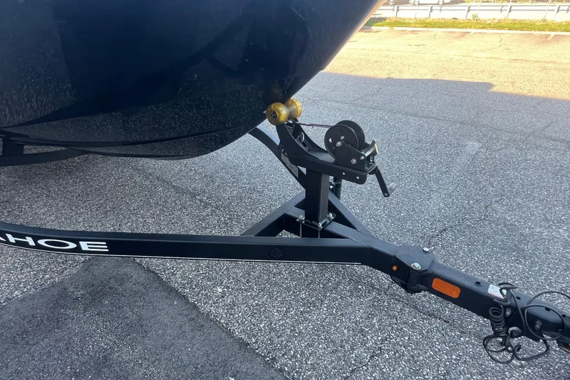 Slide: The Image of Trailer hitch of a 2023 Tahoe T18 boat on asphalt surface. - 9