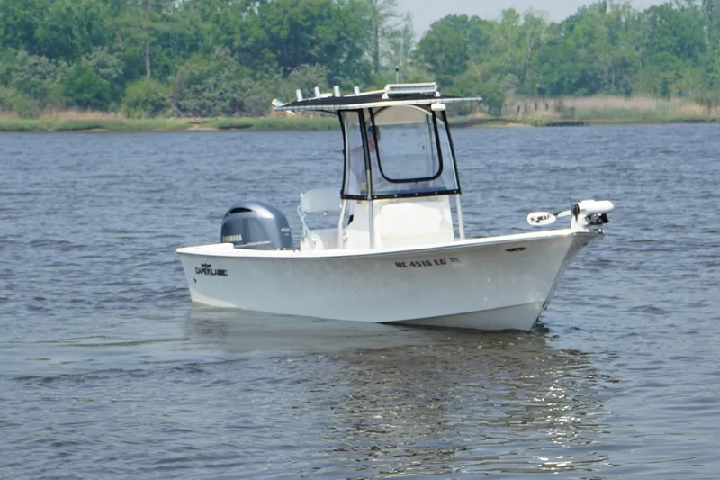 The Image of 2018 May-Craft 20 Cape Classic boat on calm water with lush green shoreline. - 1