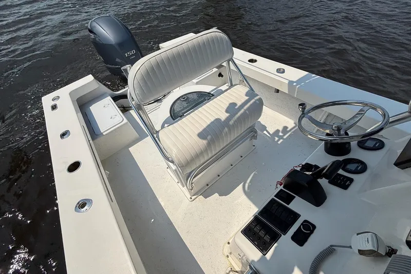 Slide: The Image of 2018 May-Craft 20 Cape Classic boat interior with steering wheel and seating. - 11