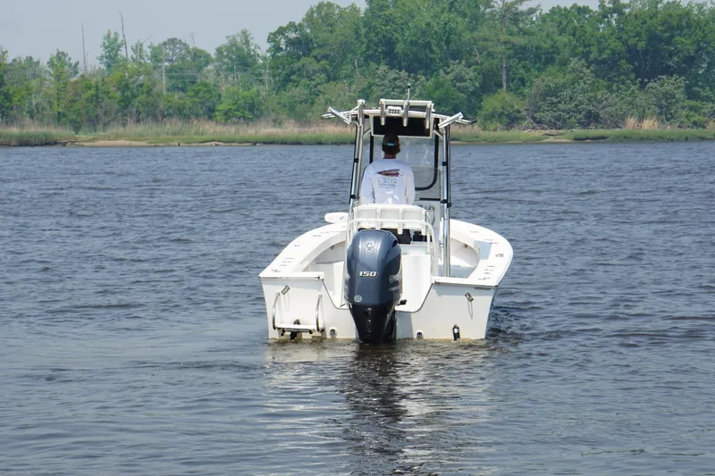 Slide: The Image of 2018 May-Craft 20 Cape Classic boat on calm water, surrounded by lush greenery. - 3