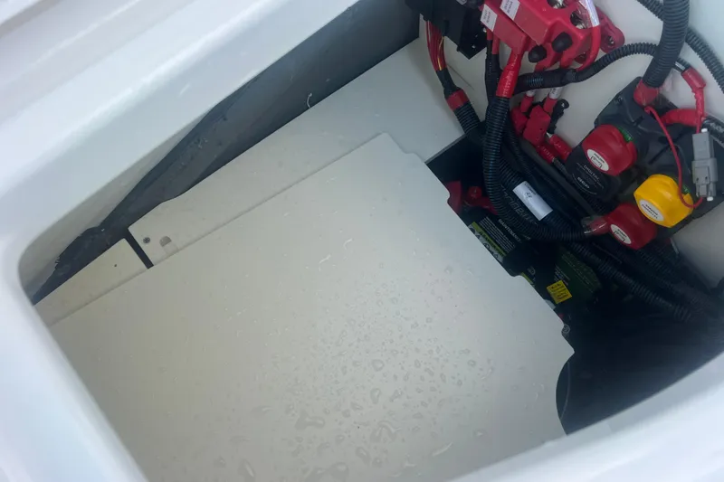 Slide: The Image of 2024 Yamaha Boats 255 FSH Sport H battery compartment with wiring and switches. - 15