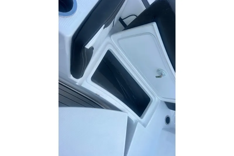 Slide: The Image of 2024 Yamaha Boats 255 FSH Sport H interior storage compartment with sleek design. - 20