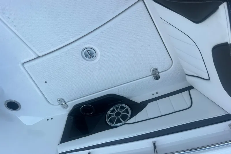 Slide: The Image of 2024 Yamaha Boats 255 FSH Sport H interior with speaker and storage compartment. - 22