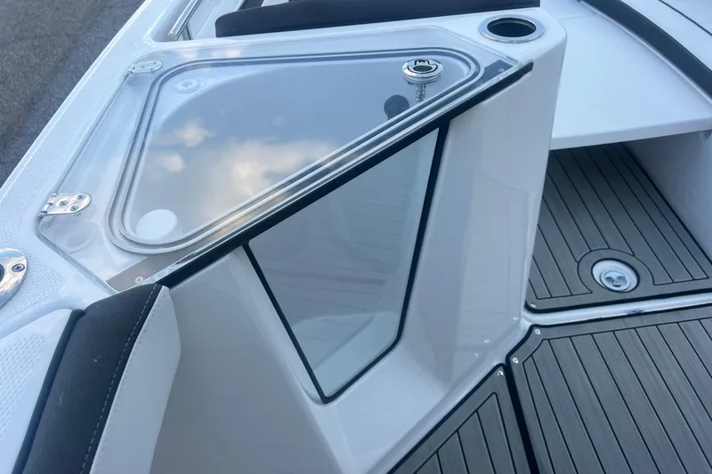 Slide: The Image of 2024 Yamaha Boats 255 FSH Sport H, featuring sleek deck design and storage compartment. - 29