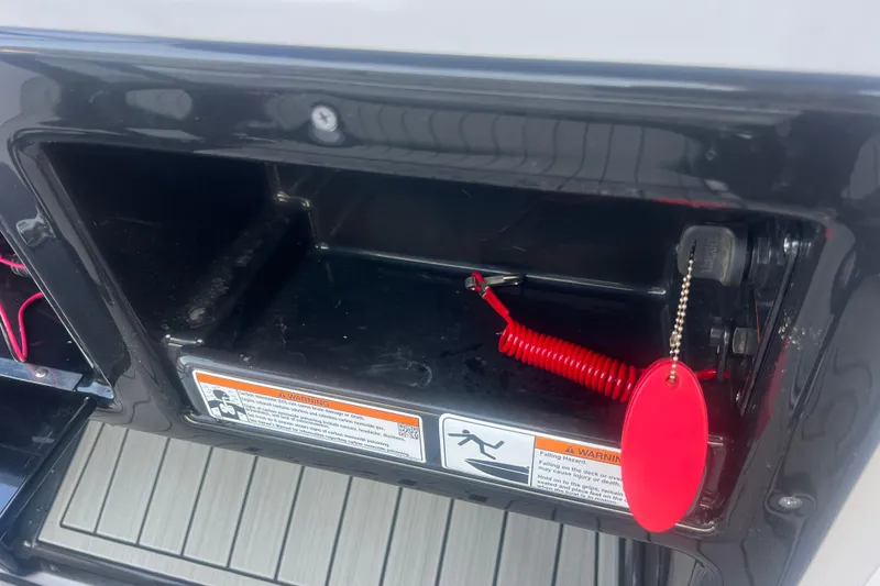 Slide: The Image of Storage compartment with safety lanyard on 2024 Yamaha Boats 255 FSH Sport H. - 33