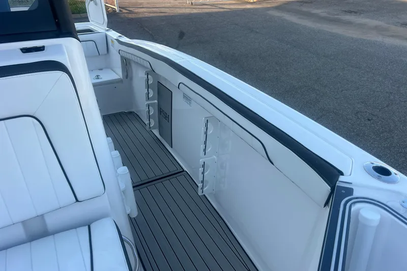 Slide: The Image of 2024 Yamaha Boats 255 FSH Sport H interior with sleek seating and storage compartments. - 37