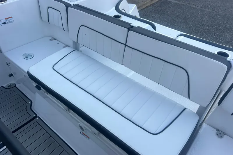 Slide: The Image of 2024 Yamaha Boats 255 FSH Sport H interior seating, featuring sleek white upholstery. - 40