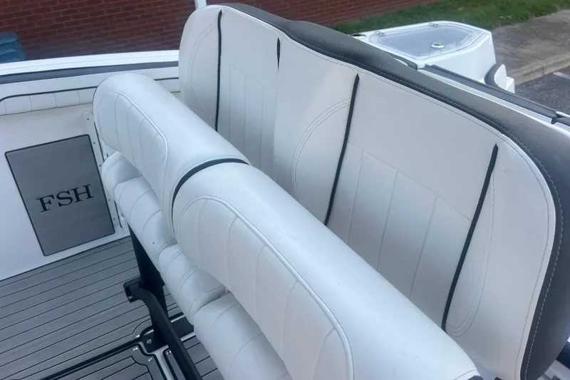 Slide: The Image of 2024 Yamaha Boats 255 FSH Sport H interior seating with white upholstery. - 41