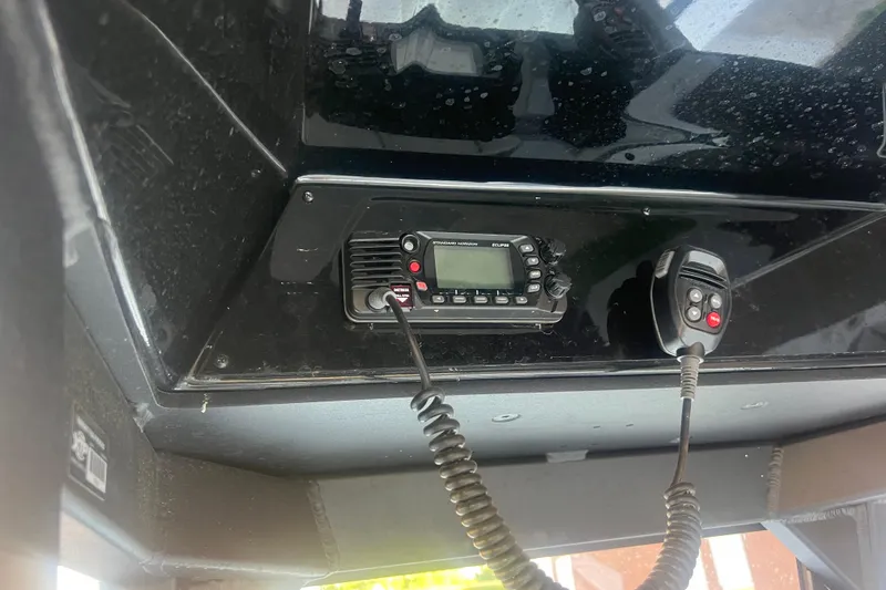 Slide: The Image of 2024 Yamaha Boats 255 FSH Sport H communication system with radio and microphone. - 49