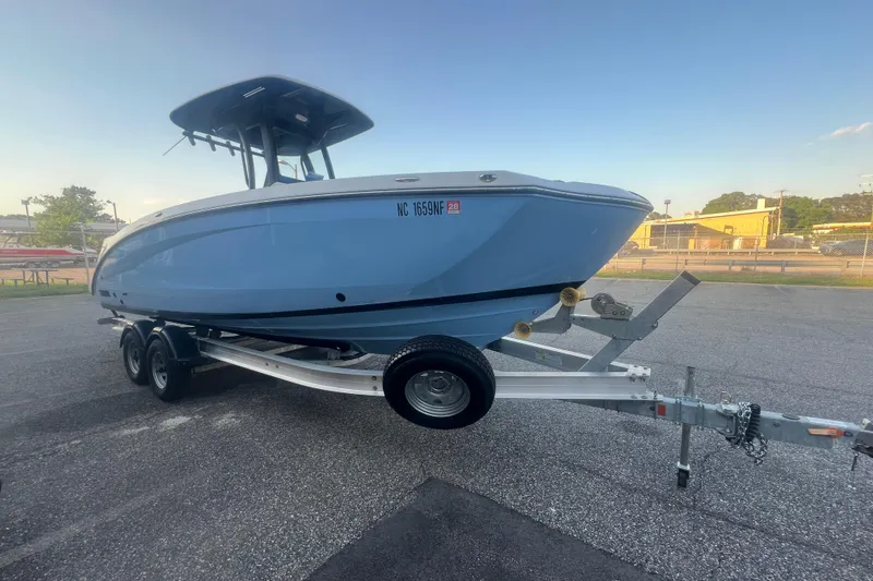 Slide: The Image of 2024 Yamaha Boats 255 FSH Sport H on trailer, parked outdoors. - 53