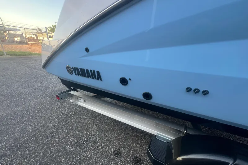 Slide: The Image of 2024 Yamaha Boats 255 FSH Sport H, rear view on trailer, showcasing sleek design. - 54