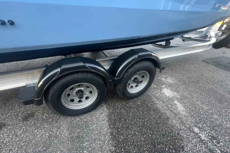 Slide: The Image of Trailer wheels of a 2024 Yamaha Boats 255 FSH Sport H on pavement. - 55