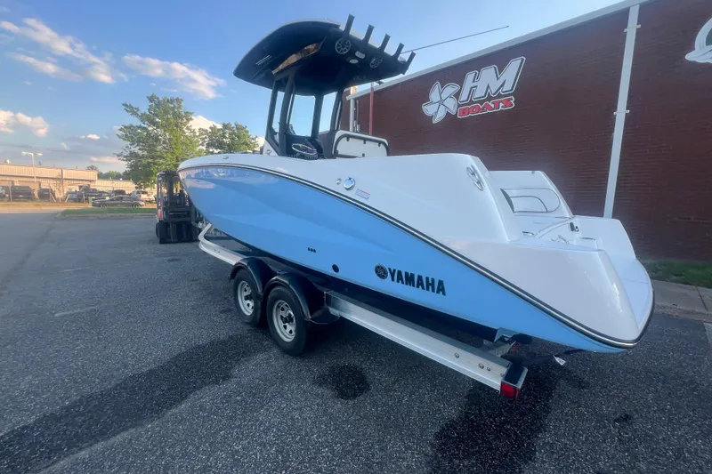 Slide: The Image of 2024 Yamaha Boats 255 FSH Sport H on trailer, parked outside HM Boats building. - 57