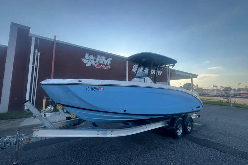 Slide: The Image of 2024 Yamaha Boats 255 FSH Sport H on trailer outside HM Boats building. - 60