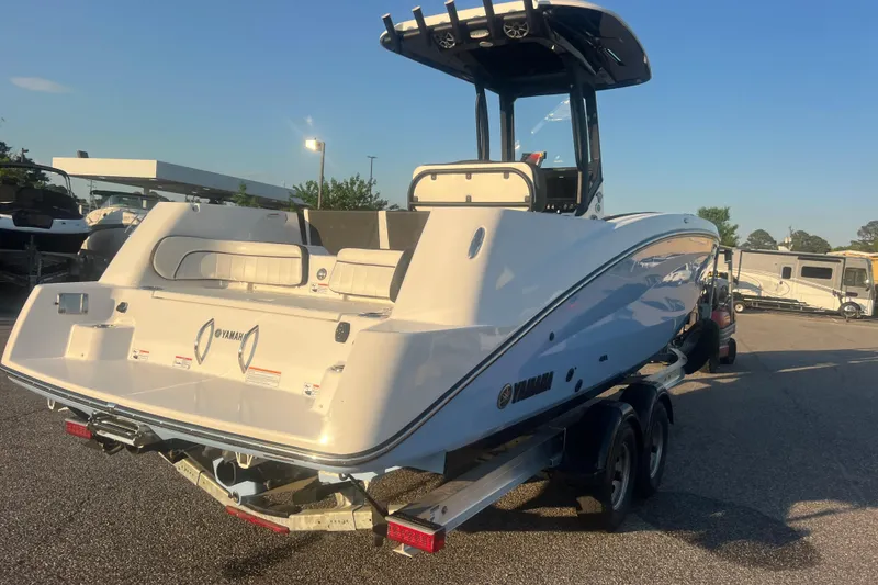 Slide: The Image of 2024 Yamaha Boats 255 FSH Sport H on trailer, rear view in outdoor setting. - 64