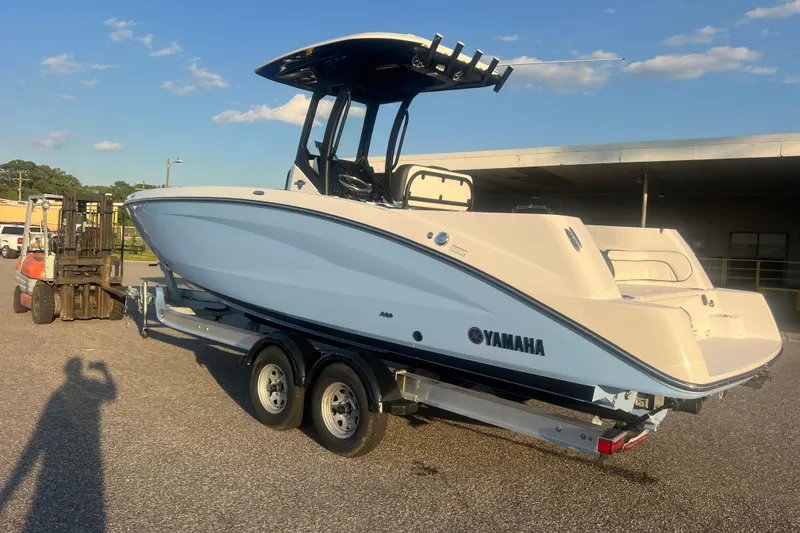 Slide: The Image of 2024 Yamaha Boats 255 FSH Sport H on trailer, parked outdoors under clear sky. - 66
