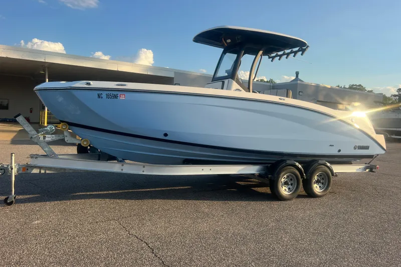 Slide: The Image of 2024 Yamaha Boats 255 FSH Sport H on trailer, parked outdoors under clear sky. - 69