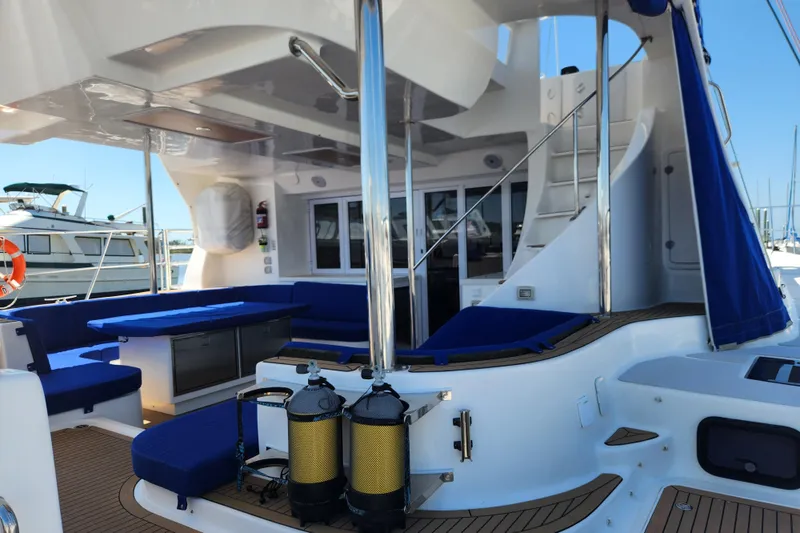 Slide: The Image of Luxurious 2021 Royal Cape Catamarans Majestic 570 yacht interior with blue seating and modern amenities. - 10