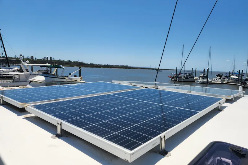 Slide: The Image of Solar panels on a 2021 Royal Cape Catamarans Majestic 570, docked at a marina. - 101
