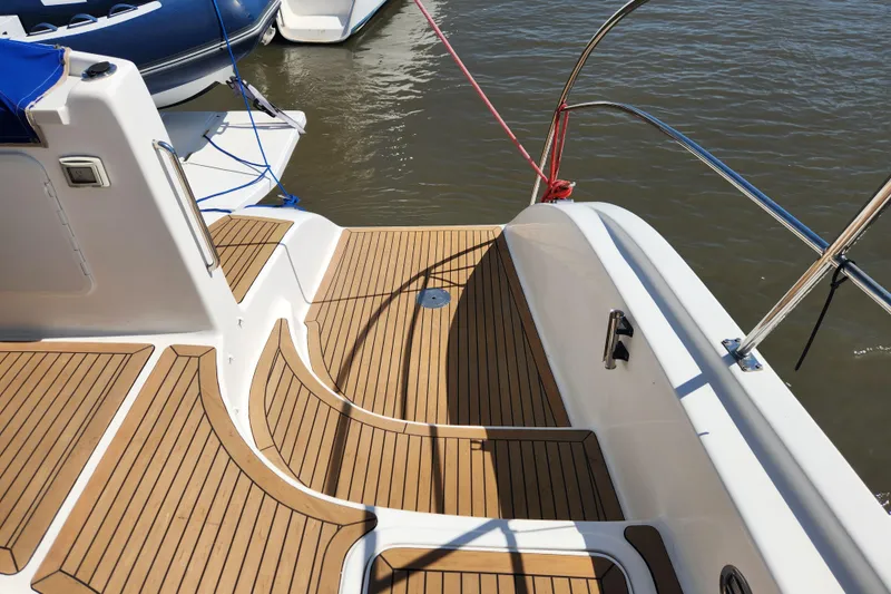 Slide: The Image of 2021 Royal Cape Catamarans Majestic 570 deck with teak flooring and water view. - 18