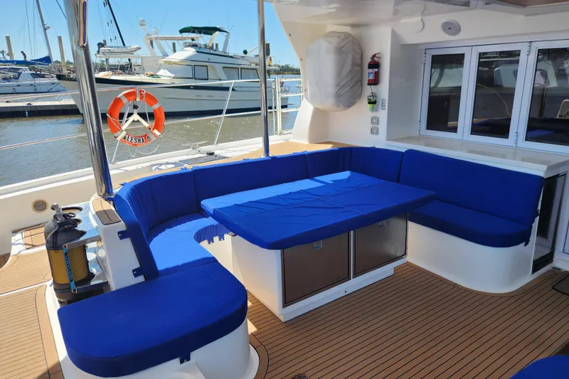 Slide: The Image of Luxurious 2021 Royal Cape Catamarans Majestic 570 with blue seating in marina setting. - 20