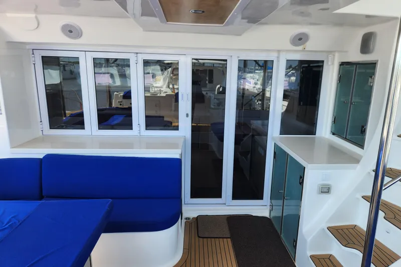 Slide: The Image of Luxurious interior of 2021 Royal Cape Catamarans Majestic 570 with blue seating and modern design. - 21