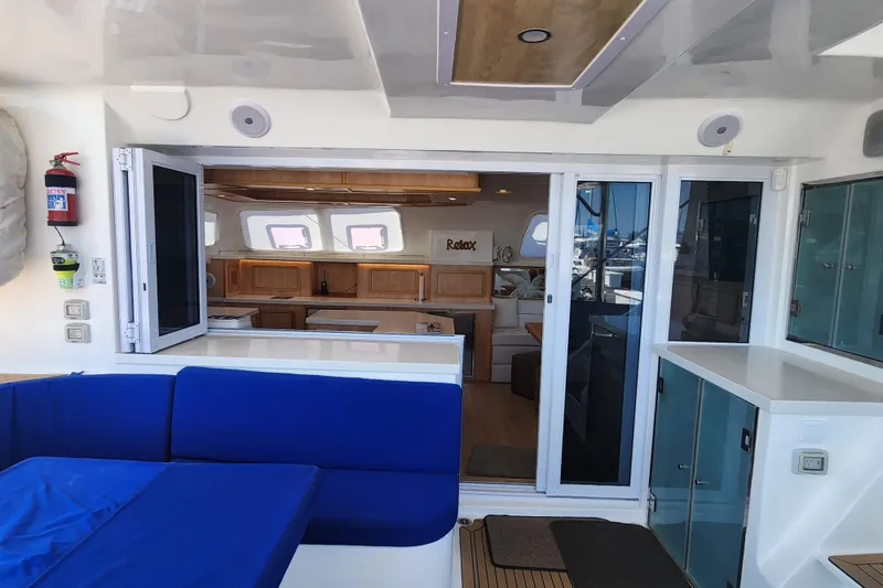 Slide: The Image of Interior view of 2021 Royal Cape Catamarans Majestic 570, featuring modern kitchen and seating area. - 22