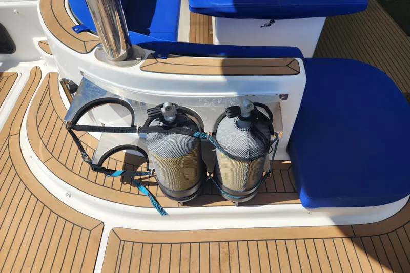 Slide: The Image of Scuba tanks on Royal Cape Catamarans Majestic 570, 2021 model, with teak deck and blue seating. - 25