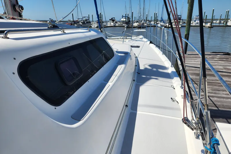 Slide: The Image of 2021 Royal Cape Catamarans Majestic 570 docked, showcasing sleek deck design and marina backdrop. - 27