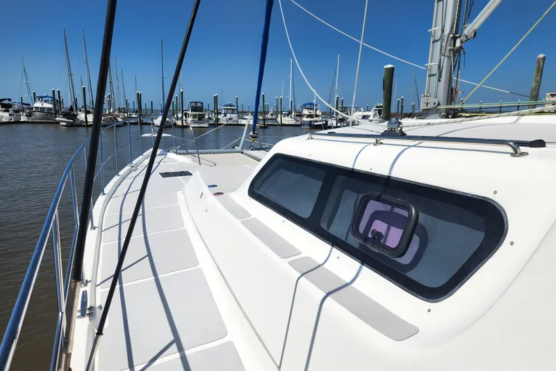 Slide: The Image of 2021 Royal Cape Catamarans Majestic 570 docked at marina, showcasing sleek deck design. - 28