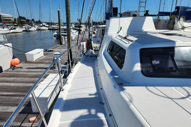 Slide: The Image of Royal Cape Catamarans Majestic 570, 2021 model, docked at a marina with clear blue skies. - 30