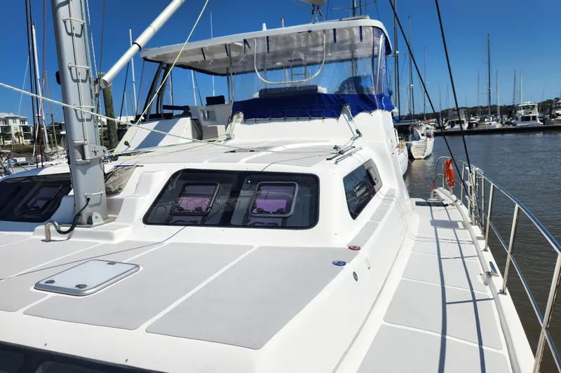 Slide: The Image of 2021 Royal Cape Catamarans Majestic 570 docked at marina under clear blue sky. - 31