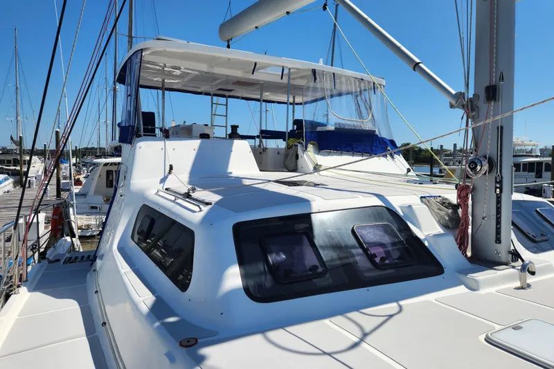 Slide: The Image of 2021 Royal Cape Catamarans Majestic 570 docked, showcasing sleek design and spacious deck. - 32